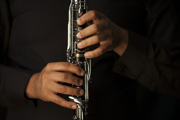 Hands of a clarinet player in black