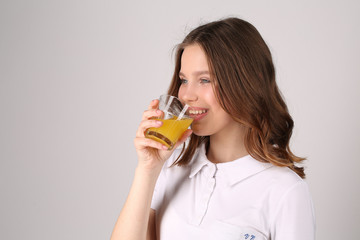 Teen drinking juice. Close up. White background