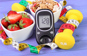 Glucometer with sugar level, healthy food, dumbbells and centimeter, diabetes, healthy and sporty lifestyle