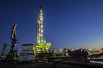 oilfield derrick at night