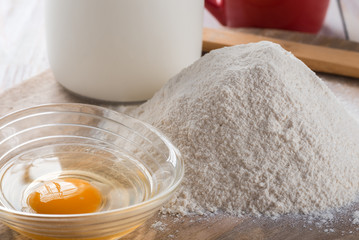 Ingredients for cooking baking - flour, egg, cookie cutters on w