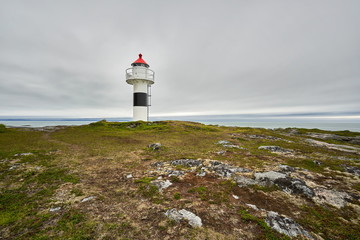 little lighthouse near a fjord in norway