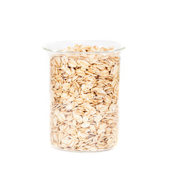 oats flakes pile in bottle on white background.