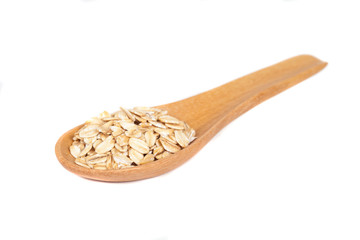 Oats flakes pile in wood spoon on white background