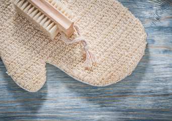 Body scrubber bath brush on wooden board sauna concept