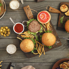 Obraz na płótnie Canvas Different burgers on wooden table