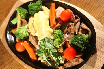 hot pan with pork and cheese