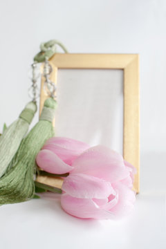 Three pink tulips around the photo frame