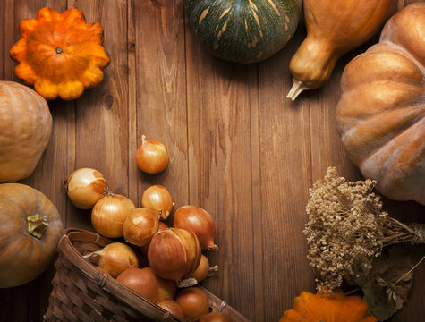 autumn pumpkins and other fruits and vegetables on wooden table