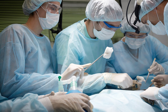 Four surgeons are on the point of starting operation