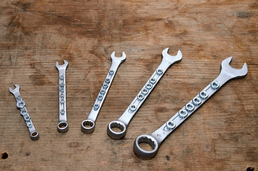Wrenches and nuts  /  Wrench set on the old dirty desk.