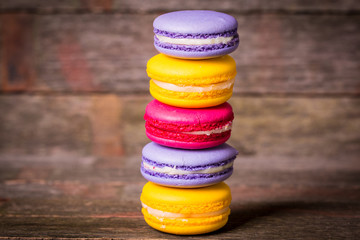 Fresh macaroons on wooden table ,vintage filter
