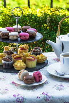 Tea with cakes and macaroons set up in the garden