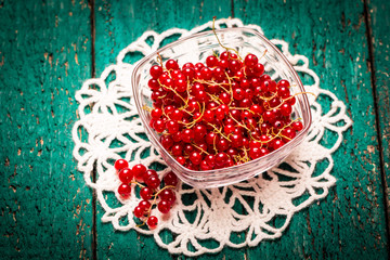 Redcurrant berries on wooden table,healthy food.
