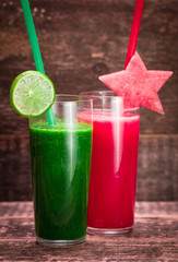 Fresh red and green smoothie on vintage wooden background.Healthy detox drink