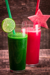 Fresh red and green smoothie on vintage wooden background.Healthy detox drink