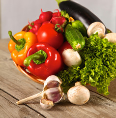 Composition with assorted raw organic vegetables wooden table