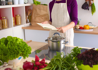 Young Woman Cooking in the kitchen. Healthy Food