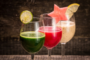 Fresh red and green smoothie on vintage wooden background.Healthy detox drink