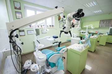 Close-up view of microscope in modern dental clinic on the background of dental chairs and other equipment used by dentists