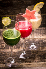 Fresh red and green smoothie on vintage wooden background.Healthy detox drink