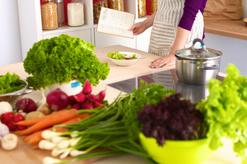 Healthy positive happy woman holding a paper shopping bag full of fruit and vegetables