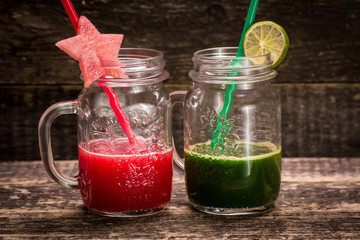 Fresh red and green smoothie on vintage wooden background.Healthy detox drink