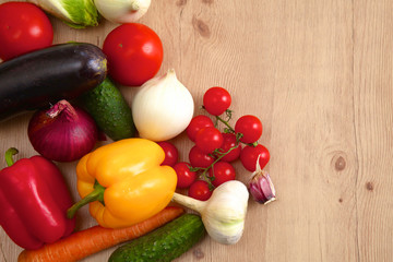 Composition with assorted raw organic vegetables wooden table