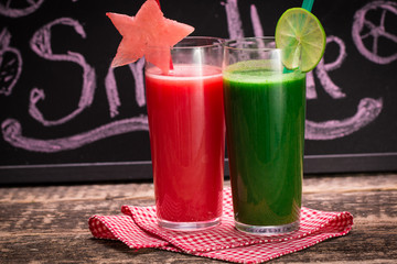 Fresh red and green smoothie on vintage wooden background.Healthy detox drink