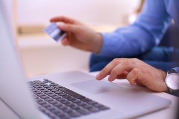 Online shopping.Hands holding credit card and using laptop