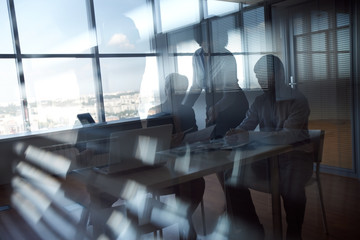 Business team working together behind blinds