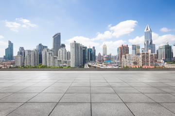 cityscape and skyline of shanghai from empty brick floor