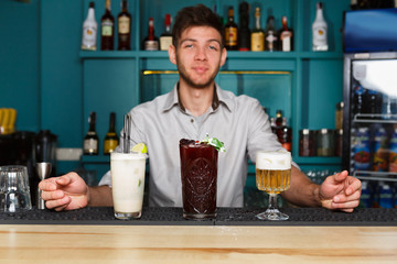 Young Barman offers non-alcoholic cocktails in night club bar