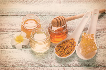 healthy honey composition, wooden background, vintage filters