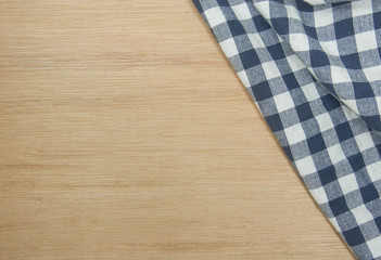 Blue Tablecloth on brown wooden table for background.