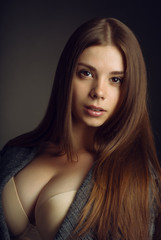 Fototapeta premium Portrait of a young beautiful brunette girl with long hair