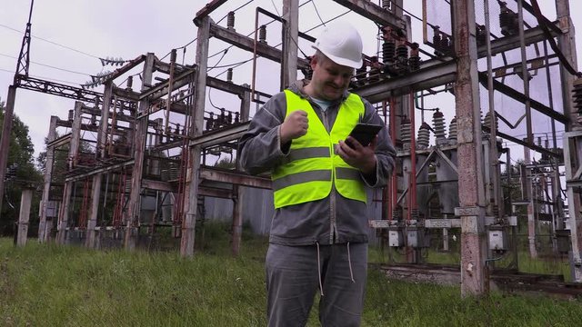Happy electrician engineer show thumb up at substation