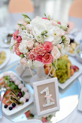Beautiful wedding restaurant for marriage. White decor for bride and groom. Colorful decoration for celebration. Beauty bridal interior. Bouquet, food and flowers in hall