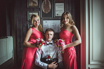 groom and bridesmaids posing for photographer