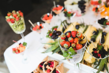 a lot of strawberries and other berries imposed in glasses