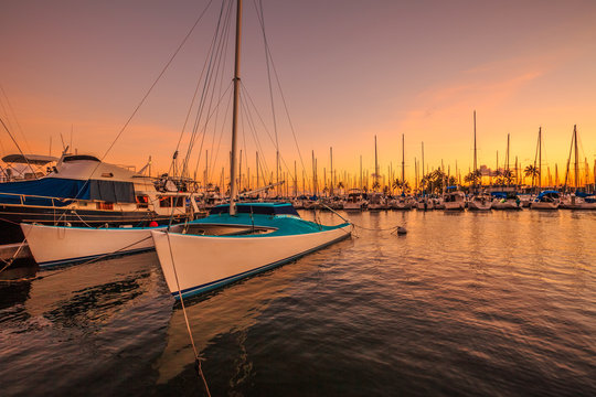 Fishing boats docked at the Ala Wai Harbor at sunset. Ala Wai Yacht Harbor is the largest yacht harbor of Hawaii, situated between Waikiki and downtown Honolulu.