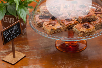 square biscuits with nuts in a glass vase and flower pot