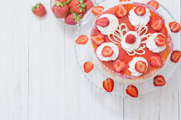 cake with strawberries on white wooden table