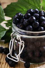 Chokeberry in a glass jar, selective focus