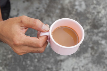 Young man holding a cup of coffee