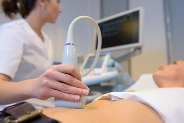 Woman having ultrasound - obrazy, fototapety, plakaty