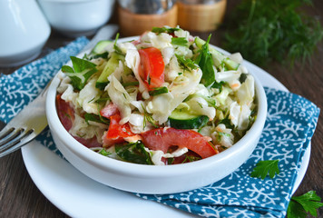 Fresh cabbage salad with vegetables and sauce.