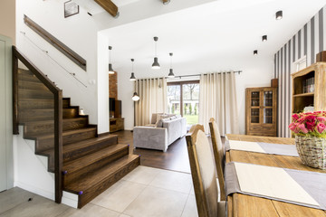 Spacious room with brick wall and stripes on the other side