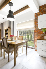 Kitchen with brick wall and stripped wall