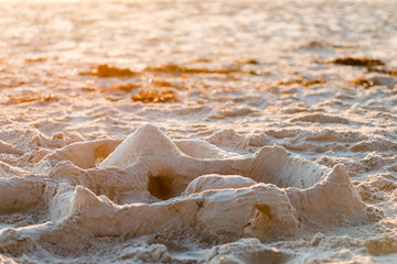 Sand castle on the beach at sunset